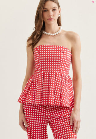 Checkered strapless peplum top featuring flared hem detail