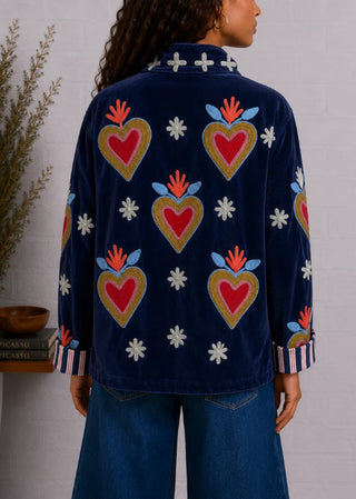 Navy velvet jacket with embroidered sacred heart motifs, floral details, and striped cuff lining, shown from back.