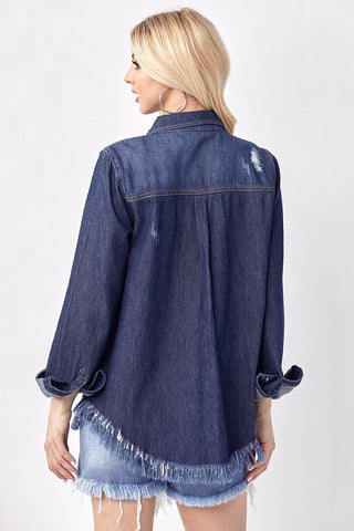 Dark blue oversized denim shirt with frayed hem, distressed details, and rolled cuffs, shown from back.