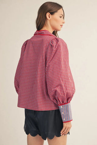 Red and blue plaid puff sleeve button-down shirt with contrast cuffs and tie neck accent, back view.