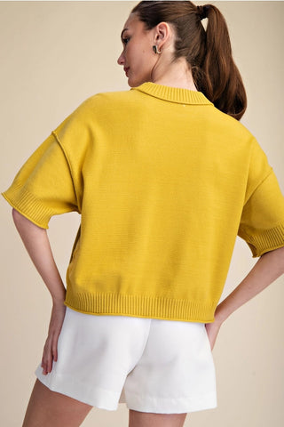 Yellow knit sweater with elbow-length sleeves, ribbed hem and cuffs, relaxed cropped fit, back view.
