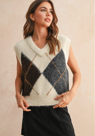 Cream and charcoal argyle pattern knit sweater vest with V-neckline and brown accent lines.