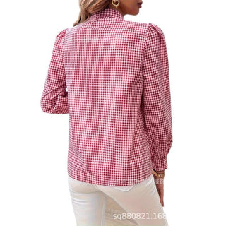 Red and white gingham plaid long sleeve button-up shirt with puff shoulders, worn by woman, back view.