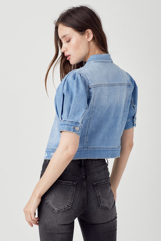 Light blue cropped denim jacket with puffed shirring sleeves, worn with dark gray skinny jeans.