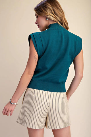 Teal high neck sleeveless fine knit sweater vest with ribbed collar and hem, back view.