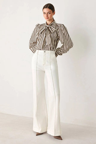 Black and white vertical striped woven top with dramatic puff sleeves and elegant bow neck tie.