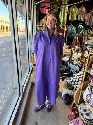 Purple midi shirt dress with ruffle collar, puff sleeves, and button-front closure, worn by smiling model.