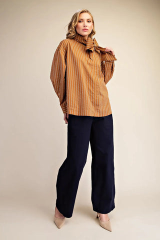 Camel brown vertical stripe high neck shirt with oversized bow tie detail and balloon sleeves.