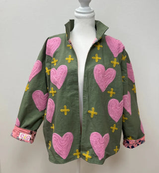 Green jacket with pink chenille hearts and yellow cross embroidery, open front, rolled cuffs with floral lining.