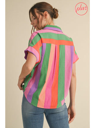 Woman wearing a multicolor striped short sleeve button-down blouse in green, pink, purple, and orange.
