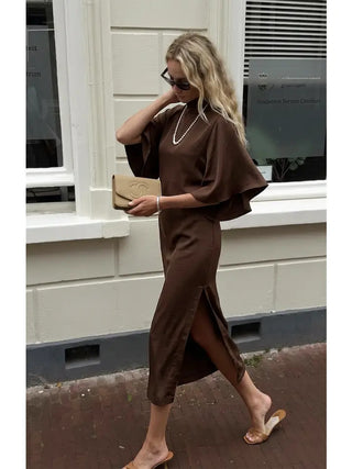 Chocolate brown satin midi dress with flutter sleeves, side slit, and elegant draped silhouette.