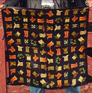 Black silk scarf featuring colorful cowboy boot pairs in orange, yellow, green, and brown on dark background.