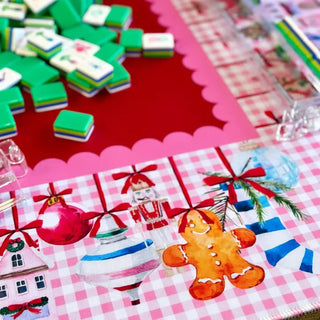 Preppy Christmas mahjong mat featuring pink gingham pattern with holiday ornaments, gingerbread man, and nutcracker illustrat