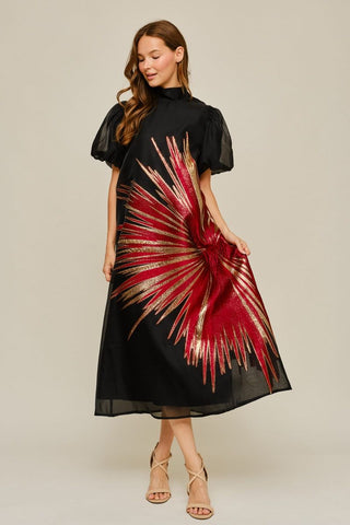 Black midi dress with red and gold metallic starburst embroidery, puff sleeves, and high mock neck.