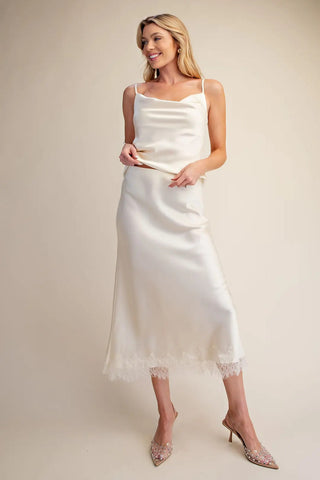 Ivory satin-effect midi skirt with delicate lace hem trim, paired with matching cowl-neck cami top.