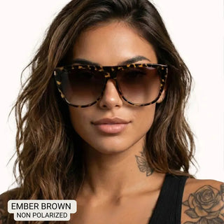 Woman wearing oversized square tortoiseshell sunglasses with brown gradient lenses, ember brown frames.