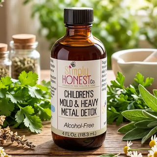 Amber glass bottle of Simply Honest Co. Children's Mold & Heavy Metal Detox, alcohol-free herbal tincture, surrounded by fres