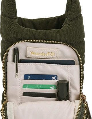 Forest green corduroy WanderFull HydroBag interior showing card slots, pen holder, and gold zipper details.