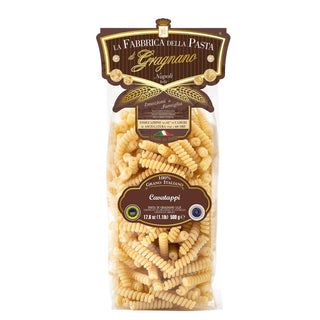 Cavatappi pasta in clear bag with brown label, spiral-shaped golden durum wheat pasta, 500g, made in Italy.