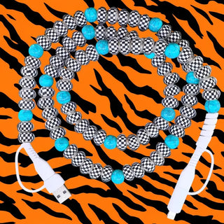 Turquoise and black-white checkered beaded USB charging cable coiled on orange tiger-print background.
