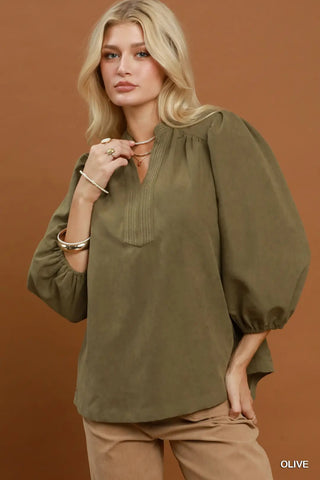 Olive sueded split neck blouse with contrast stitching, balloon sleeves, and elasticated cuffs.
