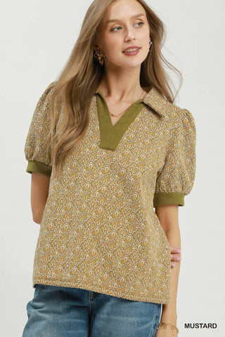 Mustard yellow floral jacquard puff sleeve top with olive green ribbed collar and cuffs, V-neckline.