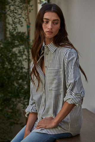 Oversized striped cotton button-front shirt in white and olive green with chest pocket and rolled sleeves.