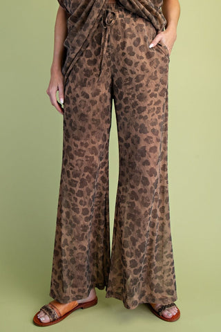 Wide-leg brown leopard print mesh pants with drawstring waist and side pockets, styled with tan sandals.