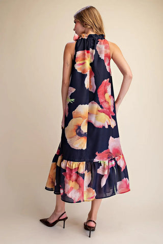 Navy blue sleeveless midi dress with large watercolor poppy floral print and ruffle hem detail.