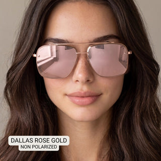 Woman wearing Dallas rose gold aviator sunglasses with light pink lenses and thin metal frames.