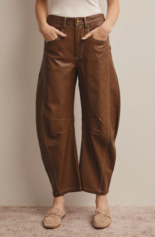 Brown faux leather wide-leg barrel pants with contrast stitching, gold button closure, and front pockets.