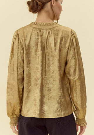 Golden metallic top with frilled tie neck, long peasant sleeves, and smocked cuffs.