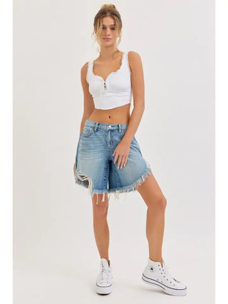 Mid waisted light wash denim cut off shorts with frayed hem and front slit detail.