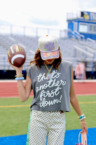 Gray sleeveless crop tank with white cursive "That's Another First Down!" graphic text, worn at football stadium.