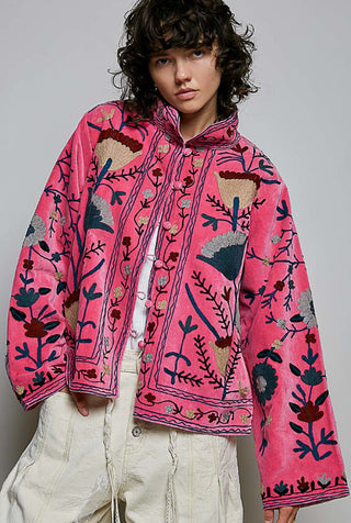 Pink velvet jacket with multicolor floral embroidery, relaxed silhouette, button front closure, wide sleeves.