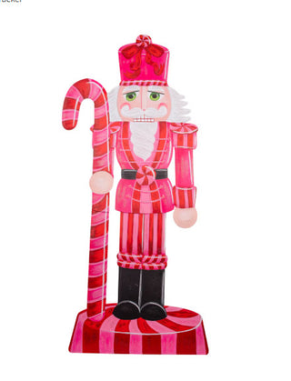 Pink and red candy-themed nutcracker yard decoration holding a candy cane staff with peppermint accents.