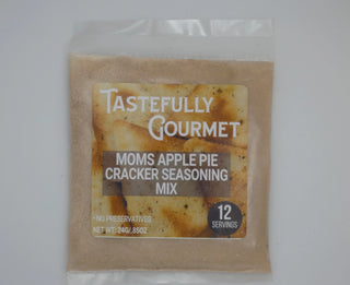 Small clear packet of Tastefully Gourmet Moms Apple Pie Cracker Seasoning Mix, tan-colored powder, 12 servings.