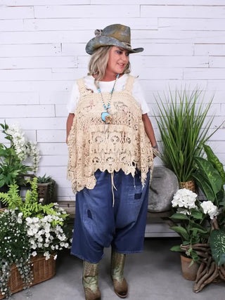 Relaxed-fit blue denim harem pants with drop crotch, cropped length, and patch detail pockets.