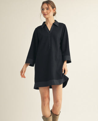 Black 3/4 sleeve collared shift dress with contrast trim, side pockets, and partial button placket.