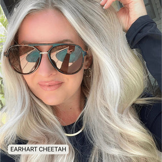 Woman wearing Earhart Cheetah polarized aviator sunglasses with brown tortoise frames and mirrored lenses.