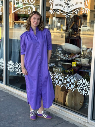 Purple midi shirt dress with ruffle collar, puff sleeves, and button front, styled with matching purple sneakers.