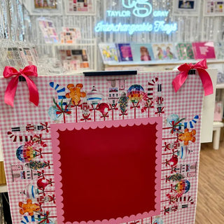 Pink gingham Mahjong mat with festive Christmas illustrations, scalloped edge center, and hot pink ribbon bows.