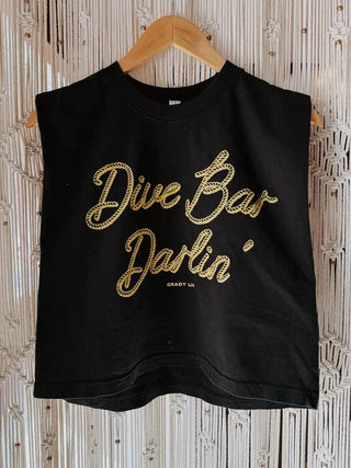 Black sleeveless muscle tank top with gold script "Dive Bar Darlin'" text, displayed on wooden hanger.