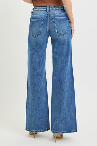 Medium blue wide leg jeans with two-tone wash, high rise waist, back pockets, worn with nude heels.