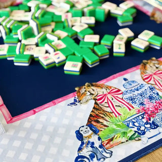 Navy mahjong mat featuring chinoiserie tiger and blue-and-white ginger jar design with green mahjong tiles scattered above.