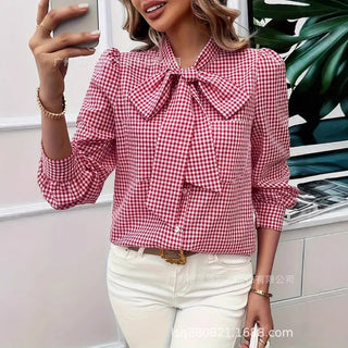 Red and white plaid long sleeve blouse with bow tie neck detail and front pocket.