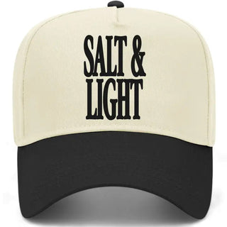 Cream and black two-tone baseball cap with bold "Salt & Light" text printed on front panel.