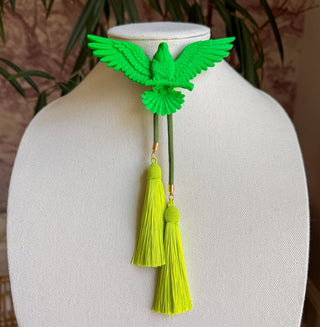 Neon green eagle brooch bolo tie with olive green cord and yellow-green tassel pendants on white display bust.