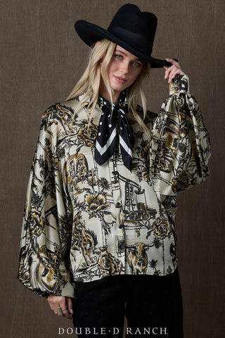 Cream and black western toile print blouse with billowy sleeves, worn with black polka dot neck scarf and cowboy hat.