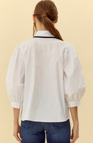 Solid top with ribbon-tie neckline featuring color trim detail